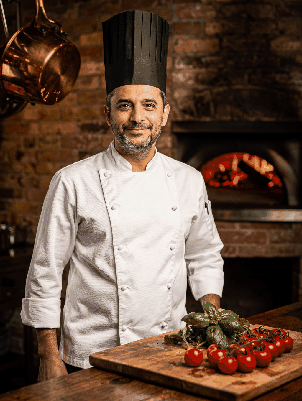 Executive Chef Alessandro Conti plating seasonal dishes in the kitchen